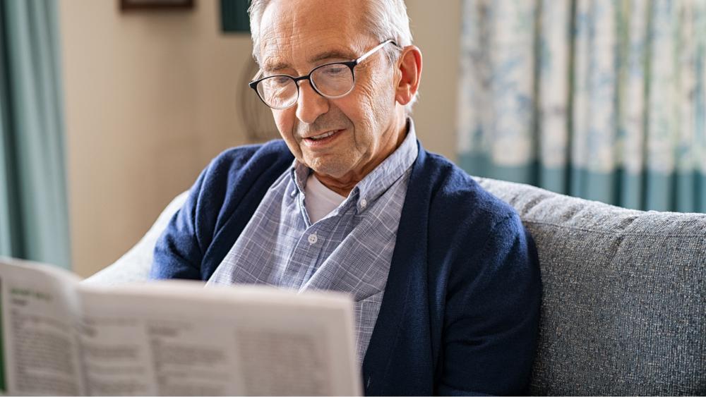 Older man reading the newspaper