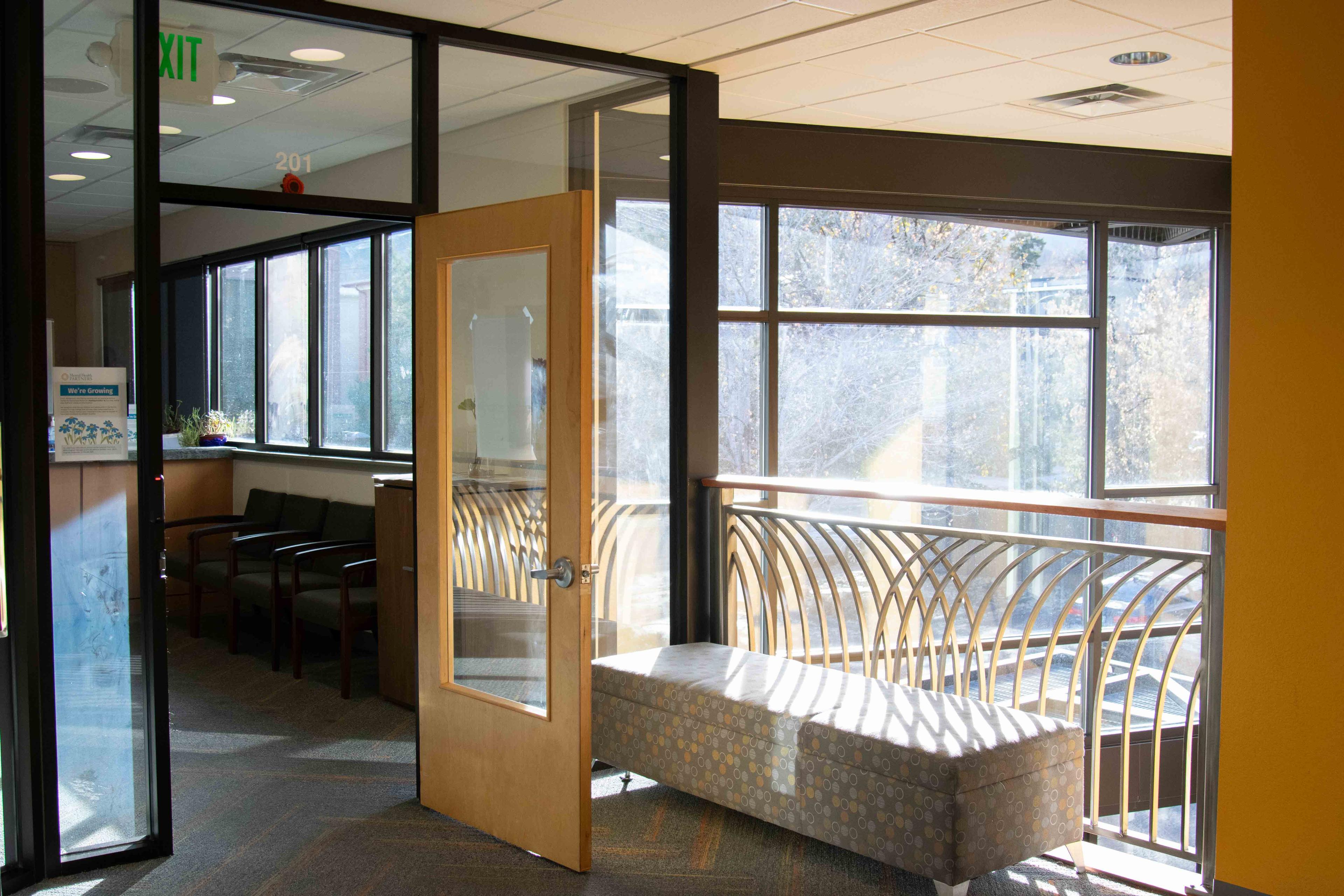 Entryway to Norton second floor lobby. Rows of windows and open door to the welcome desk.