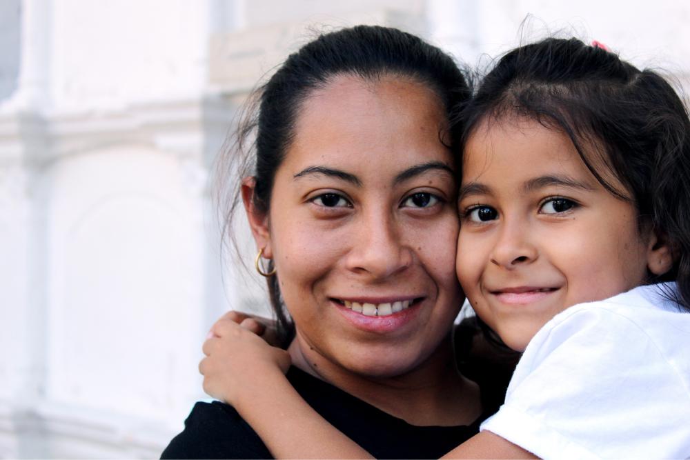 Mom holding daughter