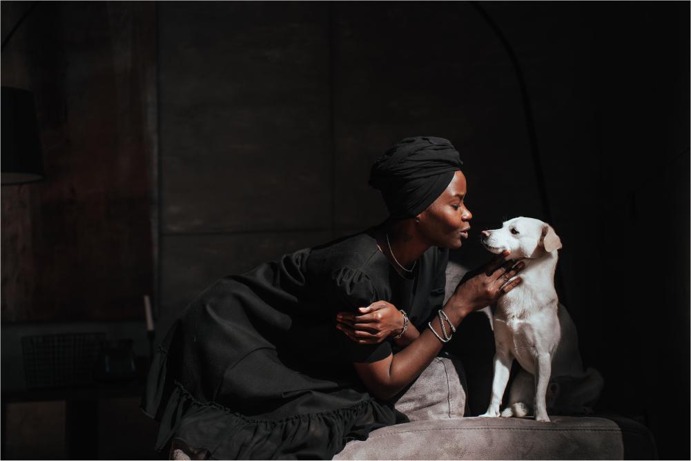 Woman lovingly looking at dog, nose to nose.