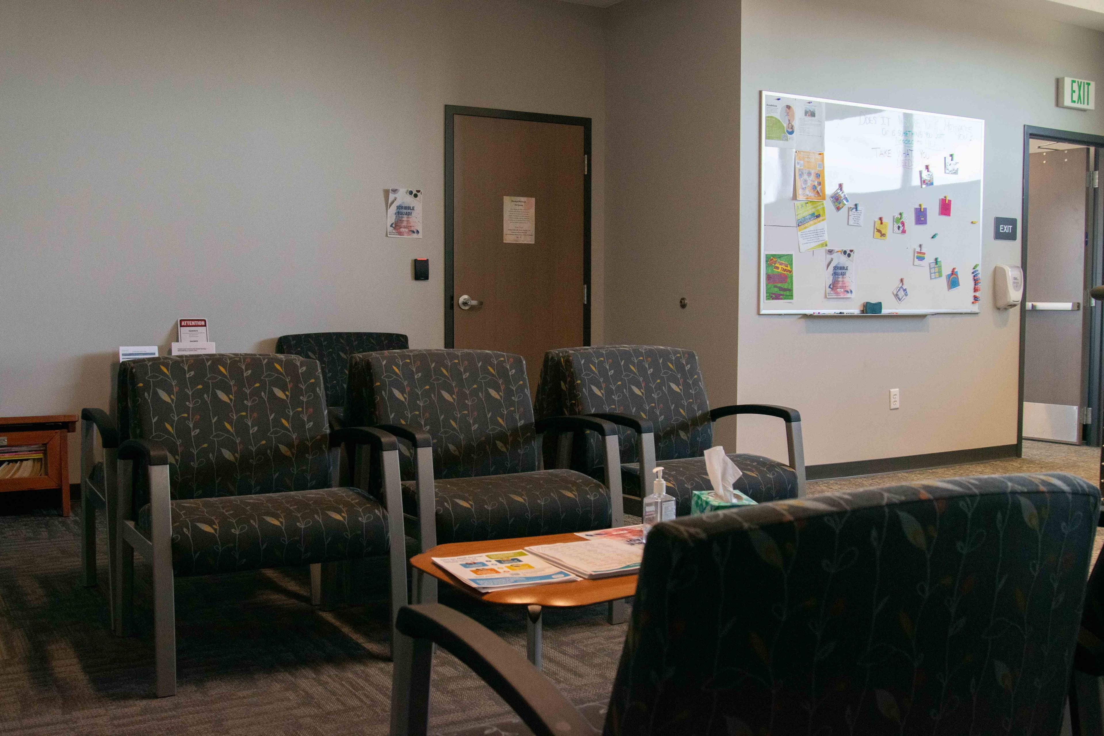 Lobby area of Broomfield office. Lines of chairs and white board in background.