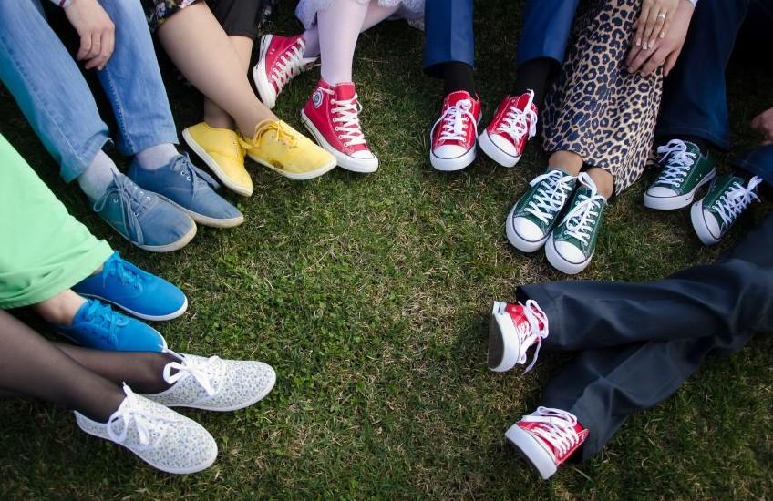 Pace Shoes of People Sitting on the Grass