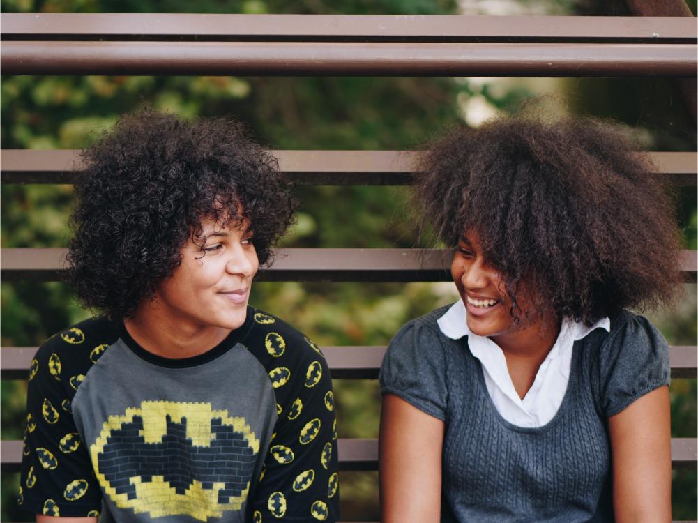 Two people looking and smiling at each other.