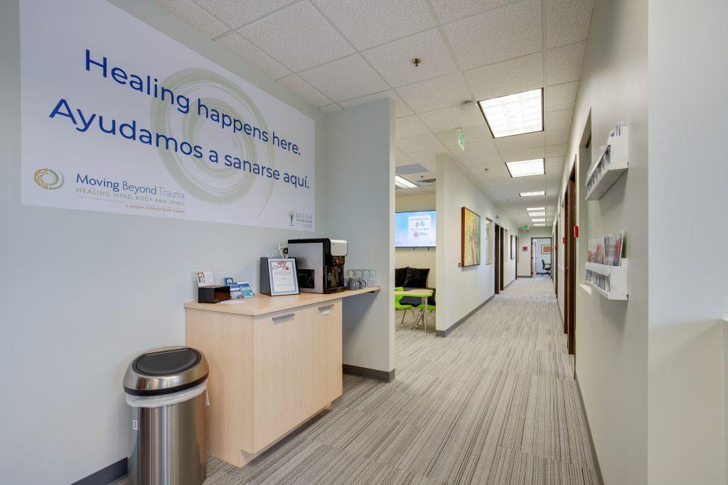 Hallway in moving beyond trauma. Carpeted floors and beige walls.