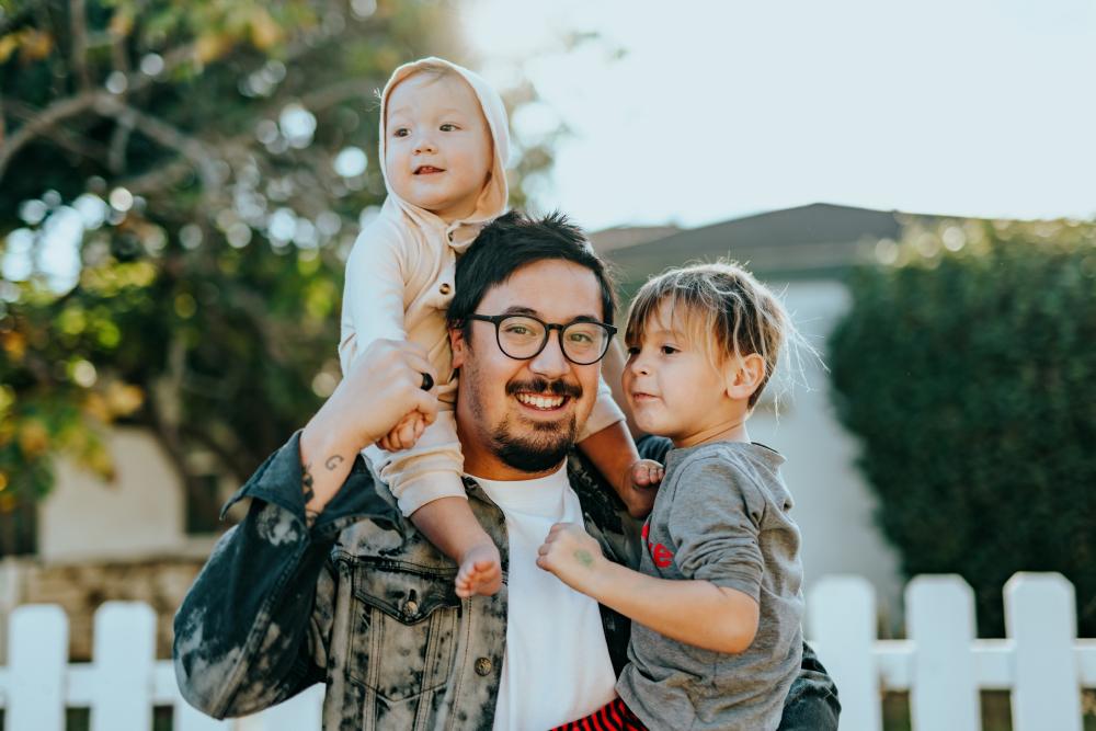 Child & Family Tile: Dad holding kids, one on shoulders one in arms.