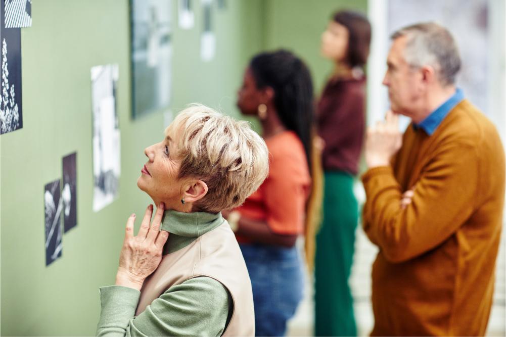 Community Event Tile: People at gallery looking at art.