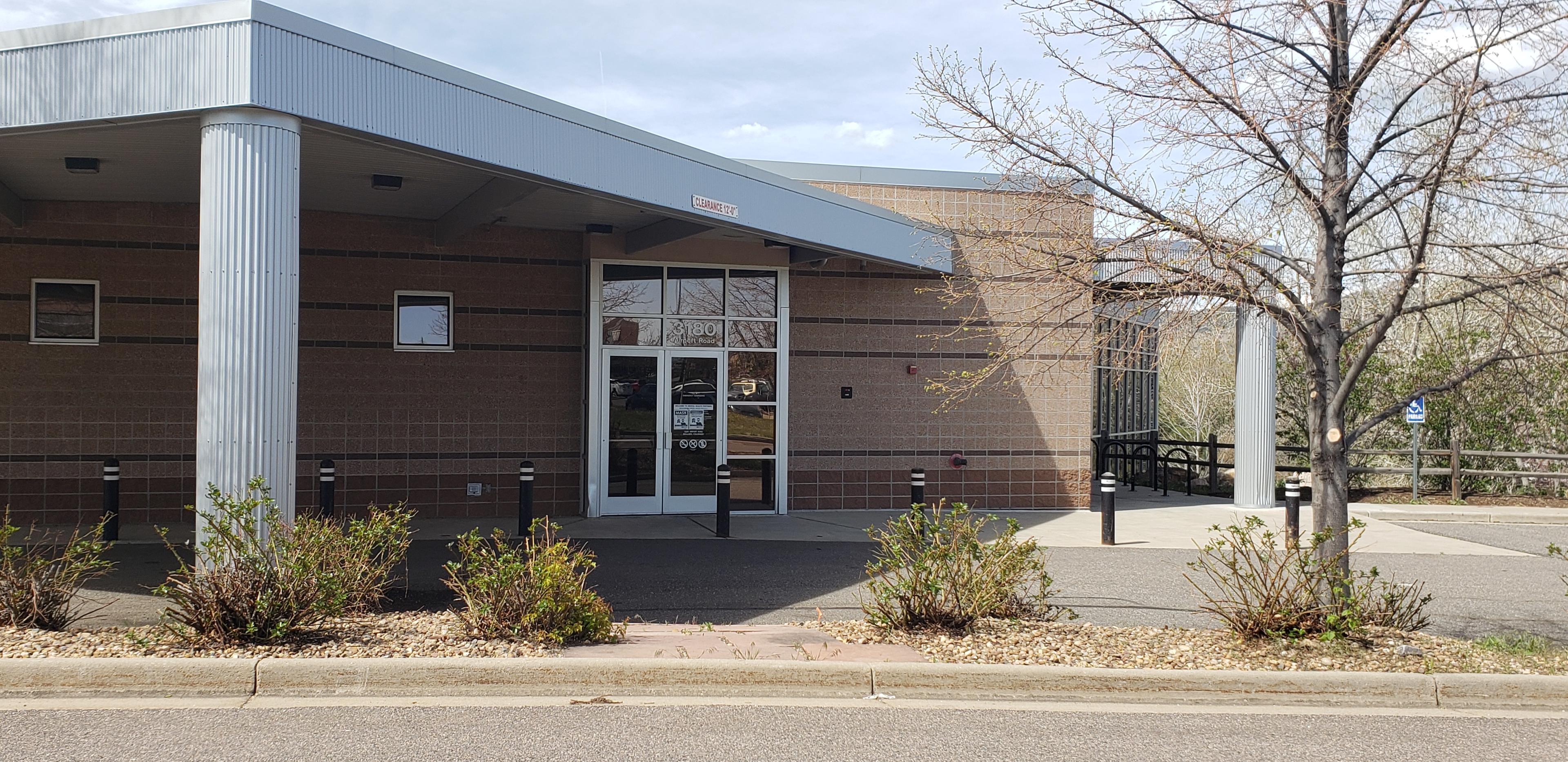 Crisis Center outside building. Tan brick and large white column.