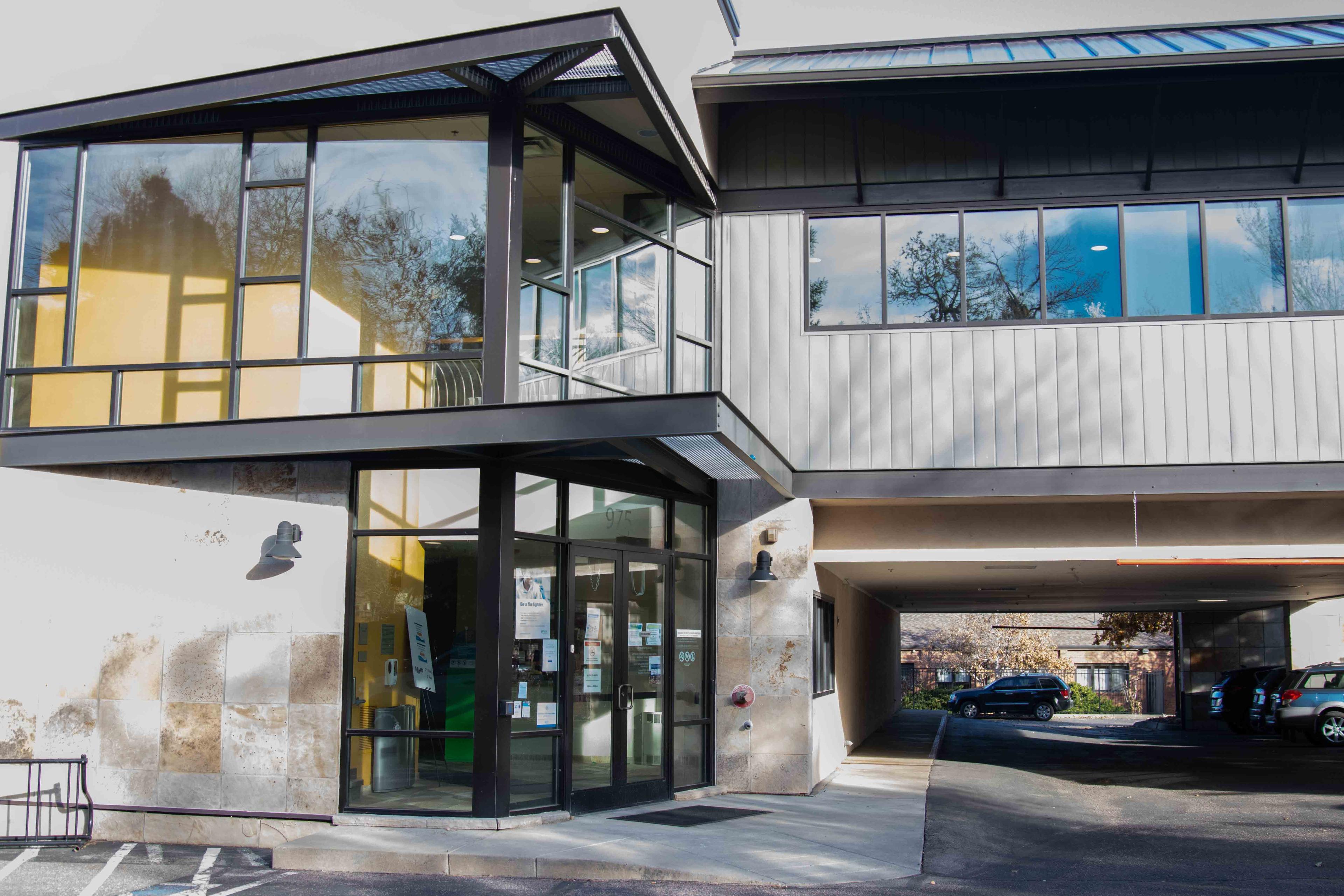 Norton Office Outside: Gray two-story building with large windows framed in black trim.