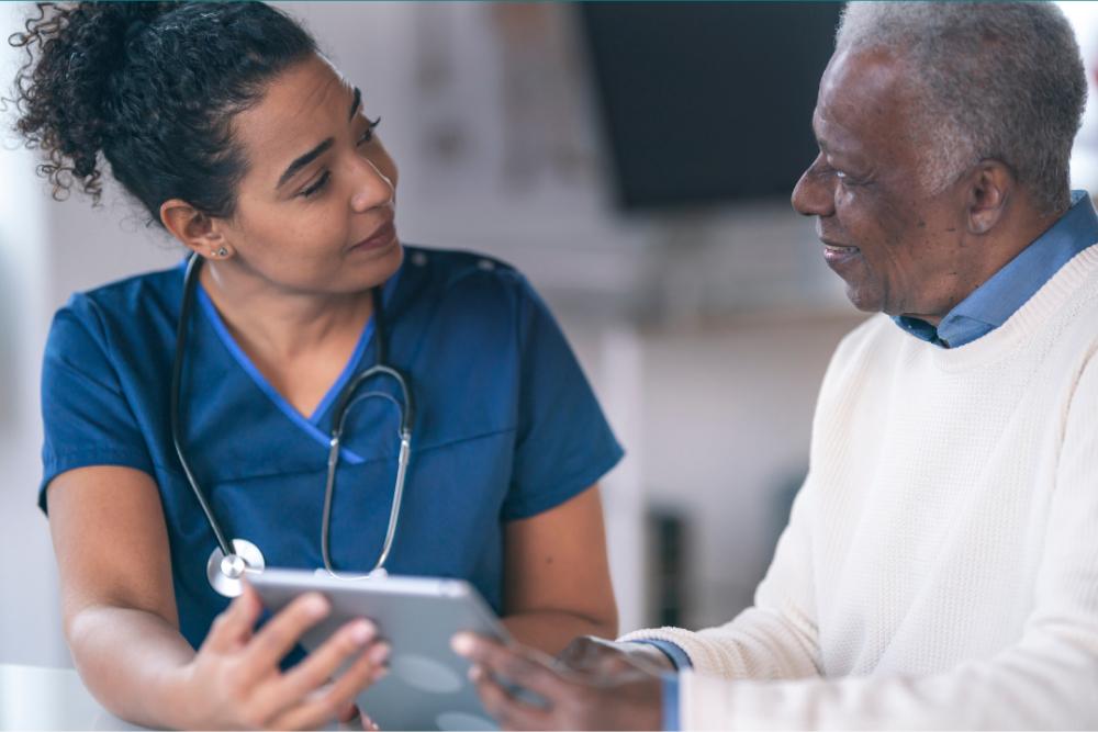 Urgent Psychiatric Care Tile: Medical staff member talking to patient while holding clipboard.