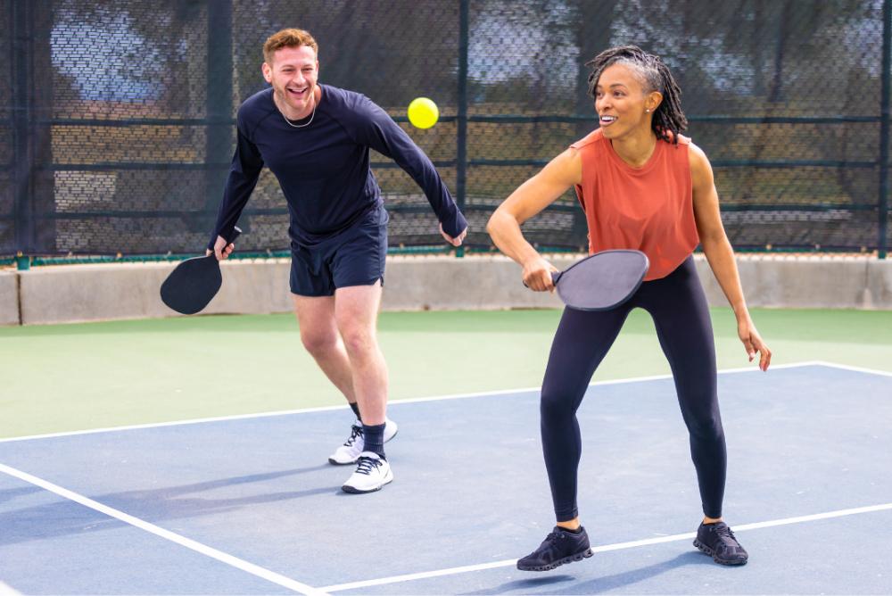 Peer Support Specialist Tile: Two adults playing pickleball.