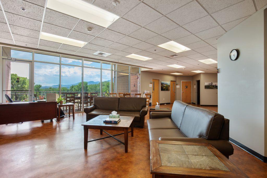 Crisis Center lounge area with leather sofas and large window wall.