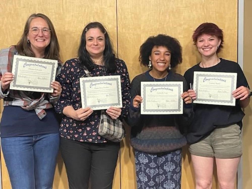 MESA Tile: Four MESA volunteers holding certificates while smiling.