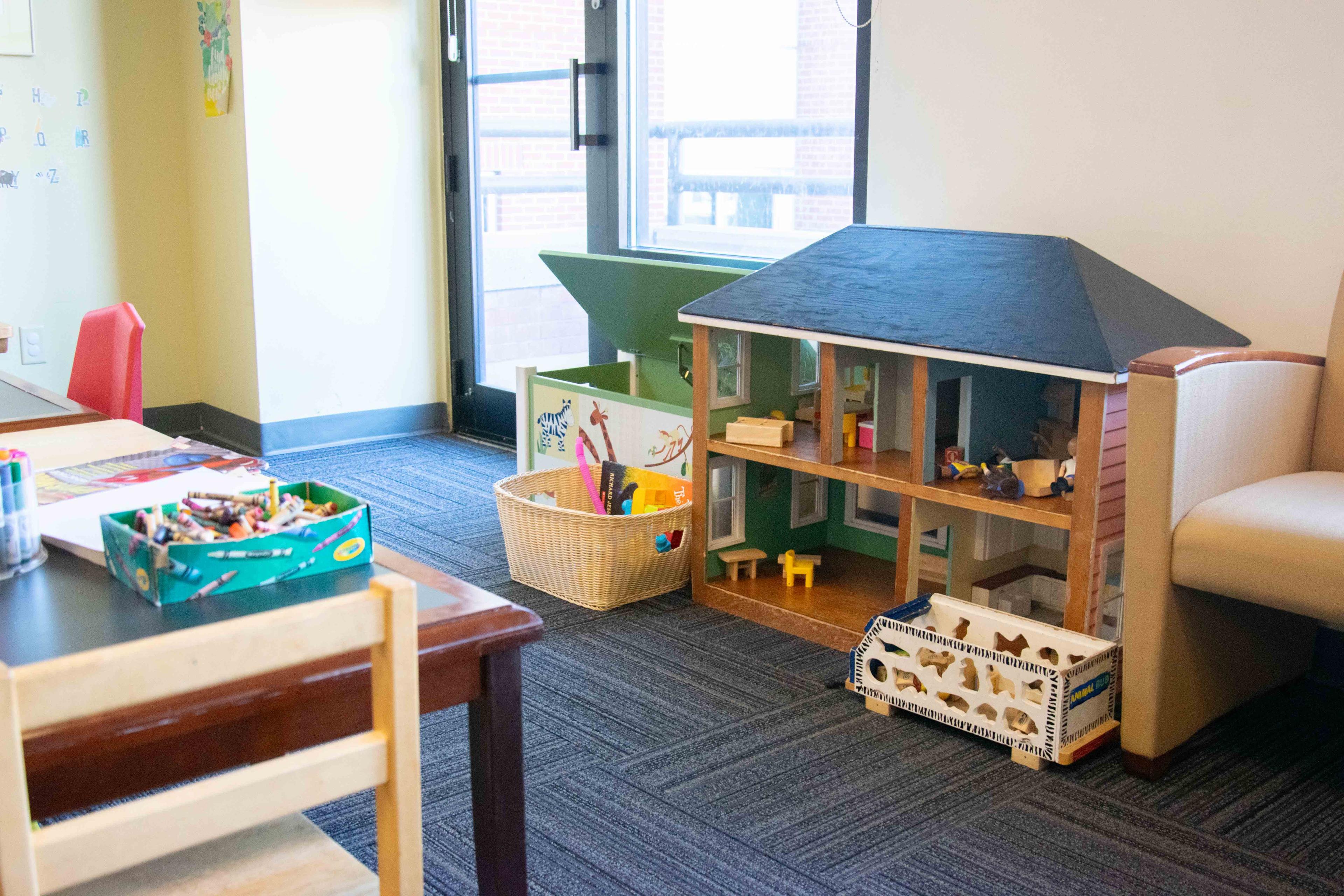 Coffman lobby play area. Doll house, crayons, and play table.